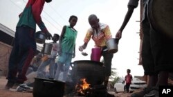 FILE - People prepare food in a Khartoum, Sudan, neighborhood on June 16, 2023. Over 42% of the population of the beleaguered country faces acute hunger, U.N. agencies said on Aug. 11, 2023.