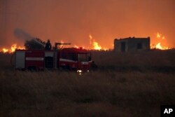 A firefighter operates during a wildfire near the northeastern town of Alexandroupolis, Greece, Aug. 20, 2023.