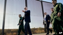 FILE - President Joe Biden walks along a stretch of the U.S.-Mexico border in El Paso Texas, Jan. 8, 2023. 