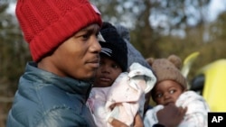 Haitian migrant Gerson Solay and his family cross into Canada at the unofficial Roxham Road border crossing north of Champlain, New York, March 24, 2023. The U.S. and Canada have reached a deal aimed at stopping asylum-seekers from crossing the border via unofficial crossings.