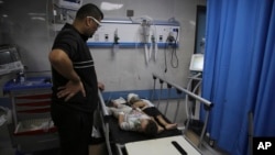 Palestinian children wounded in Israeli strikes wait for treatment in Shifa Hospital in Gaza City, Oct. 13, 2023.