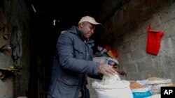 Vendor Francis Ndege measures rice at his stall in the Toi Market, Nairobi, Kenya on Wednesday, Aug. 9, 2023. Countries worldwide are scrambling to secure rice after a partial ban on exports by India cut global supplies by roughly a fifth. 
