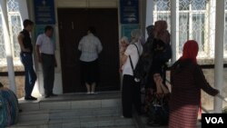 Kyrgyz State Registration Service’s branch in Osh city, Kyrgyzstan, where a line of residents await their turn, March 15, 2024. (VOA)