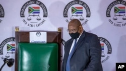 FILE - Judge Raymond Zondo, chairman of a judicial inquiry into corruption in South Africa from 2009-2018 arrives in court, in Johannesburg, South Africa, Nov. 19, 2020.