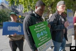 FILE - Activists participate in a rally to call for peer-led, non-police response to mental health crisis calls, in New York, Sept. 29, 2022.