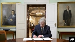 Finland's President Sauli Niinisto signs Finland's national NATO legislation in Helsinki, Finland, March 23, 2023.