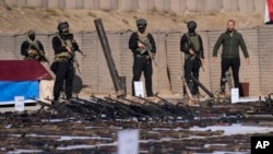FILE - The Popular Mobilization Forces display weapons seized from Islamic State militants in Salahuddin province, north of Baghdad, Iraq, Jan 12, 2023. A U.S. strike killed four PMF members in Iraq on Tuesday. 