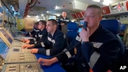 In this photo taken from video released by Russian Defense Ministry Press Service on June 11, 2024, navy personnel take part in drills on board of the Russian Kazan nuclear submarine en route to Cuba. (Russian Defense Ministry Press Service photo via AP)
