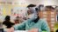 FILE - A student wears a mask and face shield in a fourth-grade class amid the COVID-19 pandemic at Washington Elementary School on Jan. 12, 2022, in Lynwood, California.