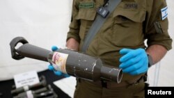 The Israeli military presents weapons and military equipment they say were used by Hamas militants from the Gaza Strip during the deadly October 7 attack, at the Tzrifin military base in central Israel, on Nov. 20, 2023. (Ammar Awad/Reuters)
