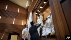 Rabbi Yehuda Teichtal, right, prepares Torah scrolls at the synagogue of the Chabad community prior to the first Shabbat service after the Hamas attacks on Israel, in Berlin, Germany, Oct. 13, 2023