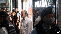 Police officers detain performance artist Sanmu Chen in the Causeway Bay area on the eve of the 35th anniversary of China's Tiananmen Square crackdown in Hong Kong, June 3, 2024.