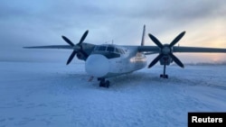 A Polar Airlines' Antonov-24 passenger aircraft following its landing on the Kolyma river in the Yakutia region, Russia, Dec. 28, 2023. (Russia's Eastern Siberian Transport Prosecutor's Office/Handout via Reuters) 