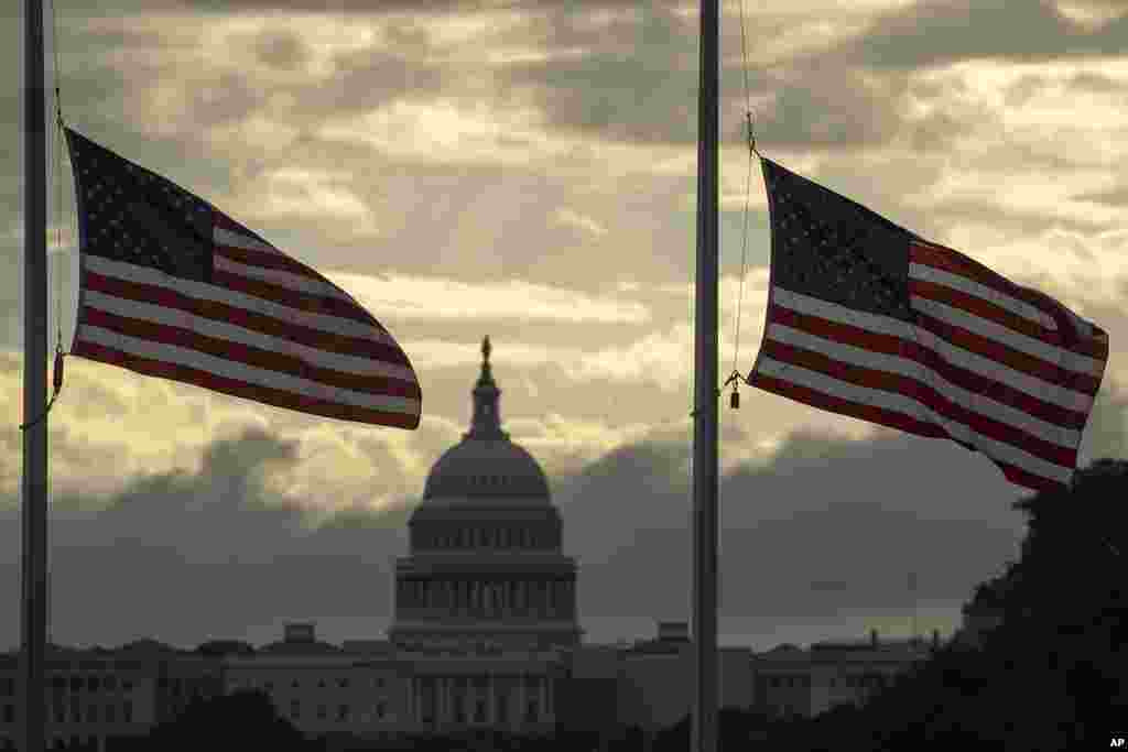 With the U.S. Capitol in the background, American flags surrounding the Washington Monument fly at half-staff in Washington, to honor and remember the victims of the Sept. 11, 2001, terror attack. 
