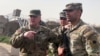 FILE - U.S. Joint Chiefs Chair Army General Mark Milley speaks with U.S. forces in Syria during an unannounced visit, at a U.S. military base in northeast Syria, March 4, 2023.