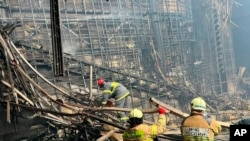 Crews work inside the Crocus City Hall on the western edge of Moscow, March 23, 2024, following an attack Friday, for which the Islamic State group claimed responsibility. (Russian Emergency Ministry Press Service via AP) 