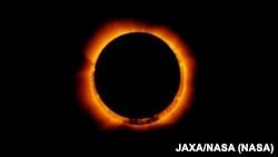 FILE - Photo of an annular solar eclipse taken by the solar optical telescope Hinode as the moon came between it and the sun. (JAXA/NASA)