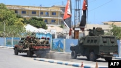 An armored personnel carrier drives near a hotel in Mogadishu on March 15, 2024. A siege at a popular hotel in the Somali capital killed three soldiers and ended early on March 15, 2024.