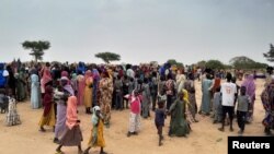 Sudanese people who fled violence in their country wait to be registered at a camp near the border between Sudan and Chad, April 26, 2023.