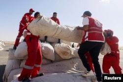 Egyptian Red Crescent members coordinate aid for Gaza, after United Nations Secretary-General Antonio Guterres visited the Rafah border crossing between Egypt and the Gaza Strip, at Al Arish Airport, Egypt, Oct. 20, 2023.