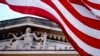 FILE - An American flag flies outside the Department of Justice building in Washington, March 22, 2019. Public confidence in American institutions has dropped, according to a new Gallup analysis.