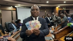 John Mushayavanhu, the new governor or the Reserve Bank of Zimbabwe, displays new banknotes of the country's currency to reporters, in Harare, April 5, 2024. (Columbus Mavhunga/VOA)