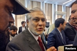 FILE - Pakistan's Finance Minister Ishaq Dar leaves after a post-budget press briefing for the 2023/24, in Islamabad, Pakistan, June 10, 2023.