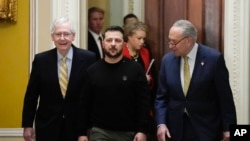 Ukrainian President Volodymyr Zelenskyy walks with Senate Majority Leader Chuck Schumer of NY, and Senate Minority Leader Mitch McConnell of Ky., during a visit to Capitol Hill in Washington, Dec. 12, 2023.