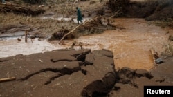 A member of the National Youth Service searches for the bodies of missing people after flash floods wiped out several homes following heavy rains in Kamuchiri village of Mai Mahiu, Nakuru County, Kenya, on May 1, 2024. 