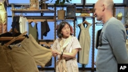 U.S. Trade Representative Katherine Tai, center, visits an outlet of outdoor equipment and clothing retailer Patagonia in Tokyo, April 19, 2023.