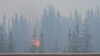 Blaze in Canadian tourist town still out of control, but rain helping firefighters 