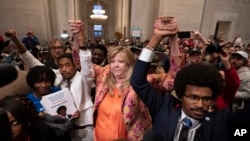 Former Representative Justin Jones, Representative Gloria Johnson, and former Representative Justin Pearson after Jones and Pearson were expelled from the Tennessee legislature in Nashville, Tennessee, April 6, 2023.