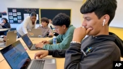 Bryan Martinez, a senior at Capital City Public Charter School in Washington, works on a computer during his Advanced Algebra with Financial Applications class on Sept. 12, 2023. (Jackie Valley/The Christian Science Monitor via AP)
