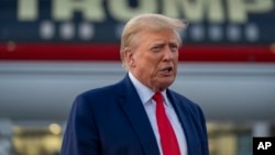 FILE - Former President Donald Trump speaks with reporters before departure from Hartsfield-Jackson Atlanta International Airport, Aug. 24, 2023, in Atlanta. 