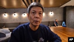 In this image taken from video footage run by TVBS, Chinese dissident Chen Siming speaks during an interview at Taoyuan International Airport's transit lounge in Taipei, Sept. 22, 2023. 