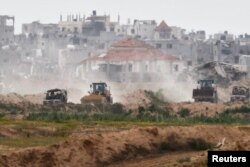 A convoy manoeuvres in Gaza, amid the ongoing conflict between Israel and the Palestinian Islamist group Hamas, as seen from Israel's border with Gaza in southern Israel, Israel March 3, 2024.