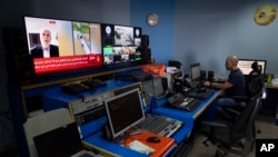 FILE - Al Jazeera broadcast engineer Mohammad Salameh works in the network's office in the West Bank city of Ramallah, May 5, 2024. Israel on Sept. 12, 2024, said it was revoking the press credentials of four Al Jazeera journalists working inside the country.