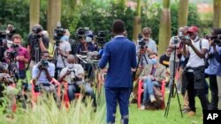 FILE - National Unity Party leader Bobi Wine addresses the media at his home in Magere, Uganda, Jan. 15, 2021. The opposition party's headquarters in the capital Kampala were sealed off on Monday ahead of planned anti-government protests. 