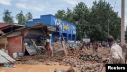 Residents salvage their household items after their homes were swamped following rains that triggered flooding and landslides in Rubavu district, Western province, Rwanda, May 3, 2023. 