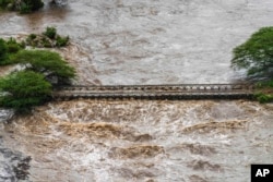 Floodwaters cover a bridge in the Maasai Mara National Reserve, leaving dozens of tourists stranded in Narok County, Kenya, on May 1, 2024.