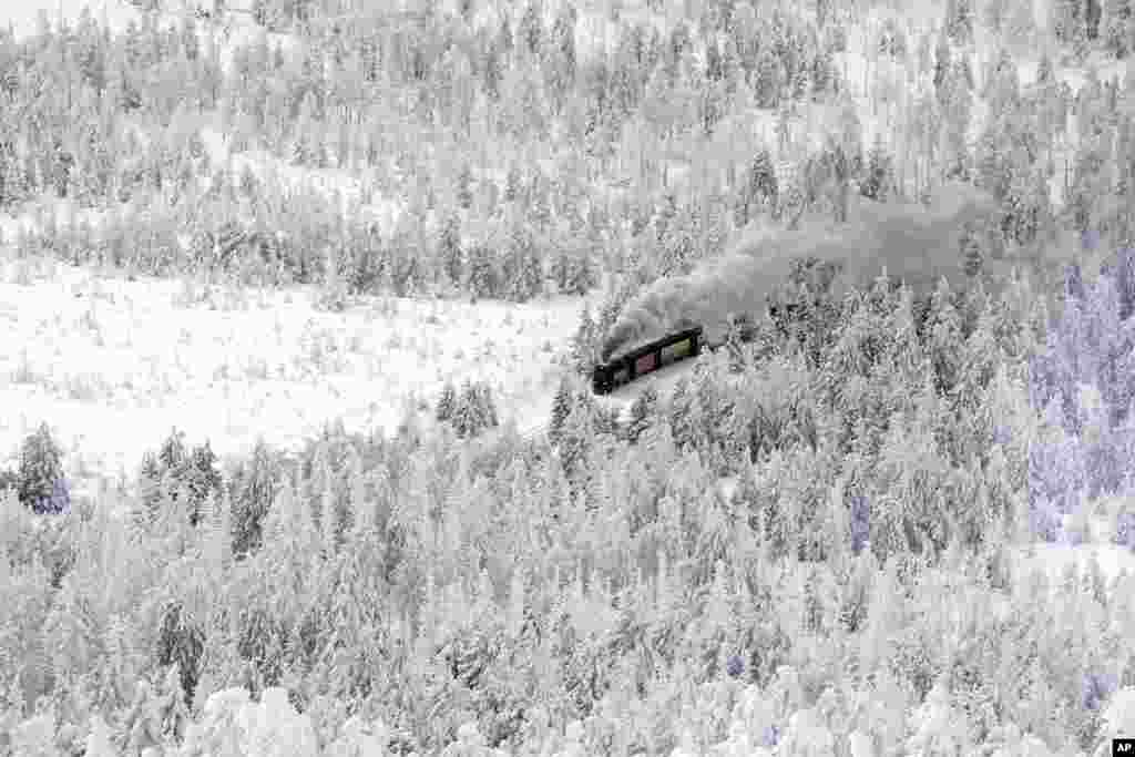 A steam train travels through a snow covered landscape on the way to northern Germany's 1,142-meter (3,743 feet) highest mountain 'Brocken' at the Harz mountains near Schierke.