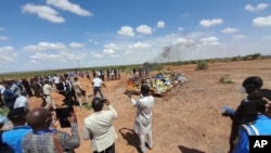 In this photo released by The United Nations Office on Drugs and Crime, officials burn seized drugs in Niamey, Niger, June 26, 2023.