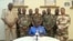FILE - In this image taken from video provided by ORTN, Col. Maj. Amadou Abdramane, front center, makes a statement on July 26, 2023, in Niamey, Niger, as a delegation of military officers appeared on Niger State TV to announce their coup.