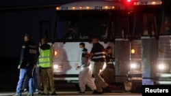 A Venezuelan migrant walks to board a repatriation flight as a part of an immigration enforcement process at the airport in Harlingen, Texas, on Oct. 18, 2023.