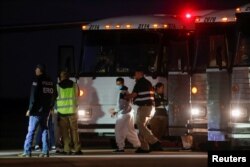 A Venezuelan migrant walks to board a repatriation flight, as a part of an immigration enforcement process, at the airport in Harlingen, Texas, Oct. 18, 2023.