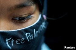 A person participates in a pro-Palestinian rally in front of the Israeli Embassy in Bangkok, Oct. 21, 2023.