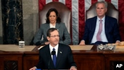 Israeli President Isaac Herzog speaks at a joint meeting of Congress, at the Capitol in Washington, July 19, 2023, as Vice President Kamala Harris and House Speaker Kevin McCarthy look on. 