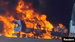 Smoke rises as a truck burns near the Myanmar-China border, near Muse, Myanmar, in this screen grab obtained from a social media video released on Nov. 23, 2023. 