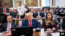 Former President Donald Trump sits in the courtroom with his legal team before the continuation of his civil business fraud trial at New York Supreme Court, in New York, Oct. 17, 2023.