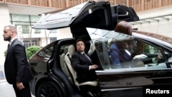 Tesla Chief Executive Officer Elon Musk gets in a Tesla car as he leaves a hotel in Beijing, China, May 31, 2023.